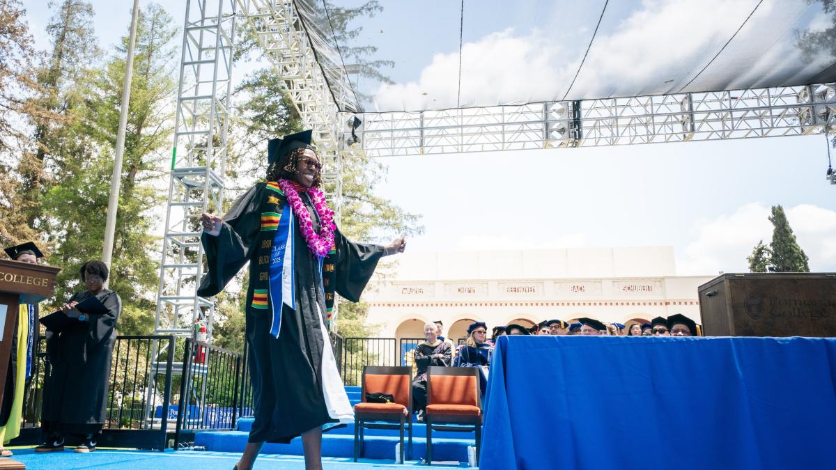 A student walks across a stage