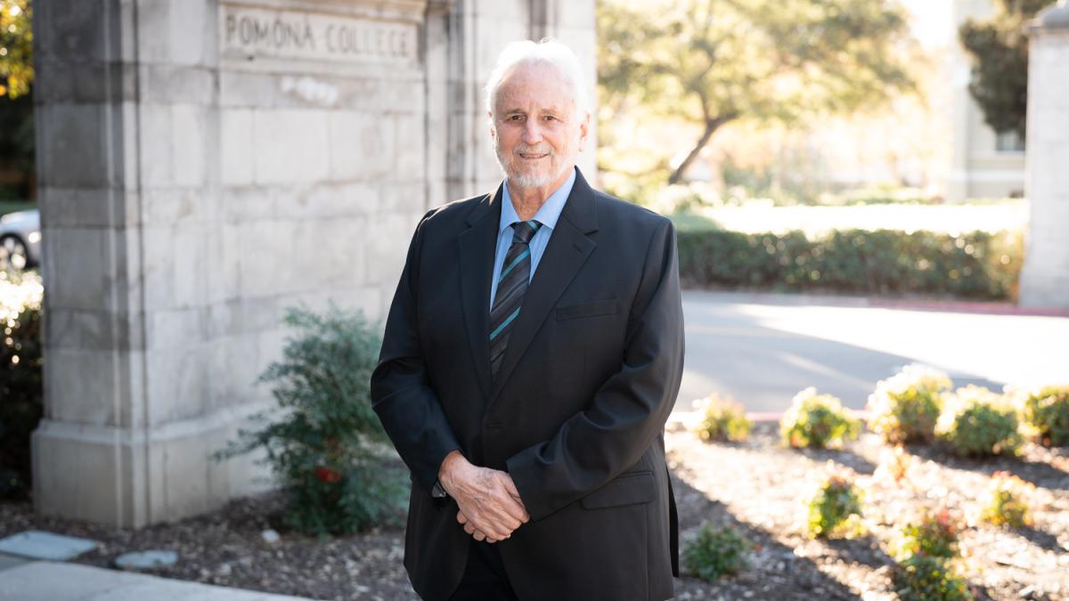 Prof. Miguel Tinker Salas standing by the Pomona College gates