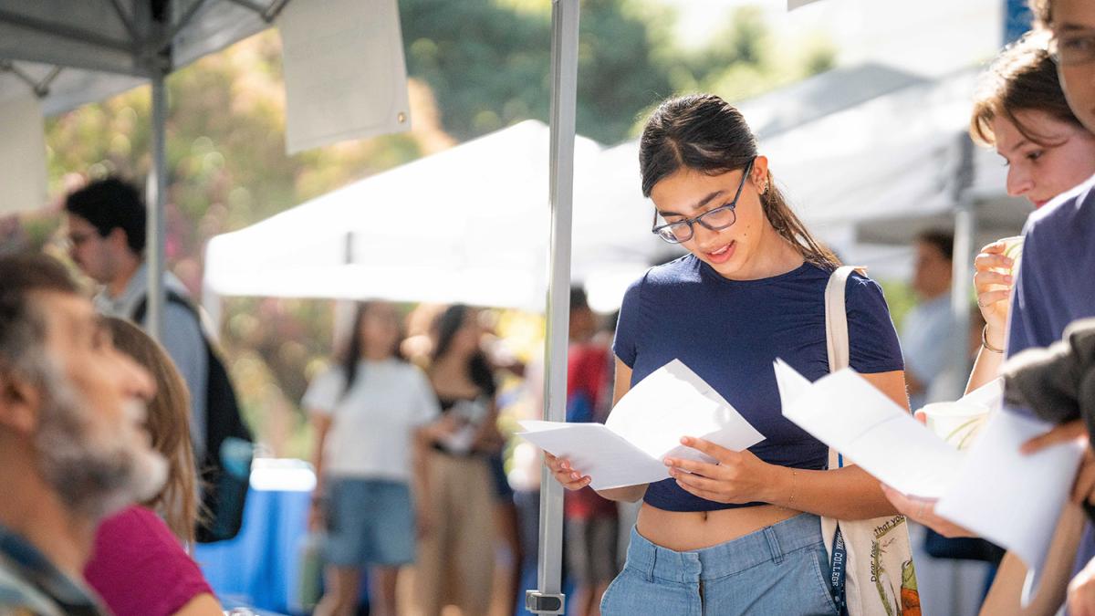 First year admissions student looking at paper