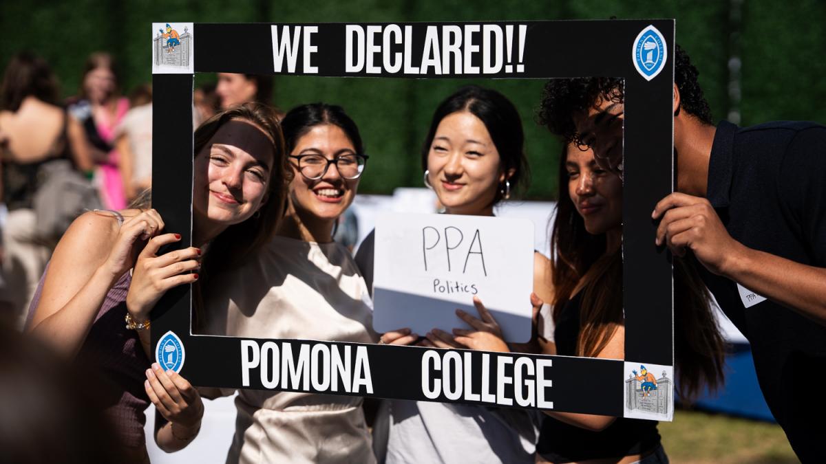 Students hold a frame