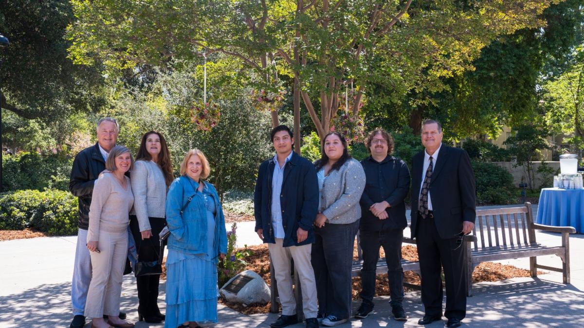 Linda Mazur's family in front of her bench and plaque