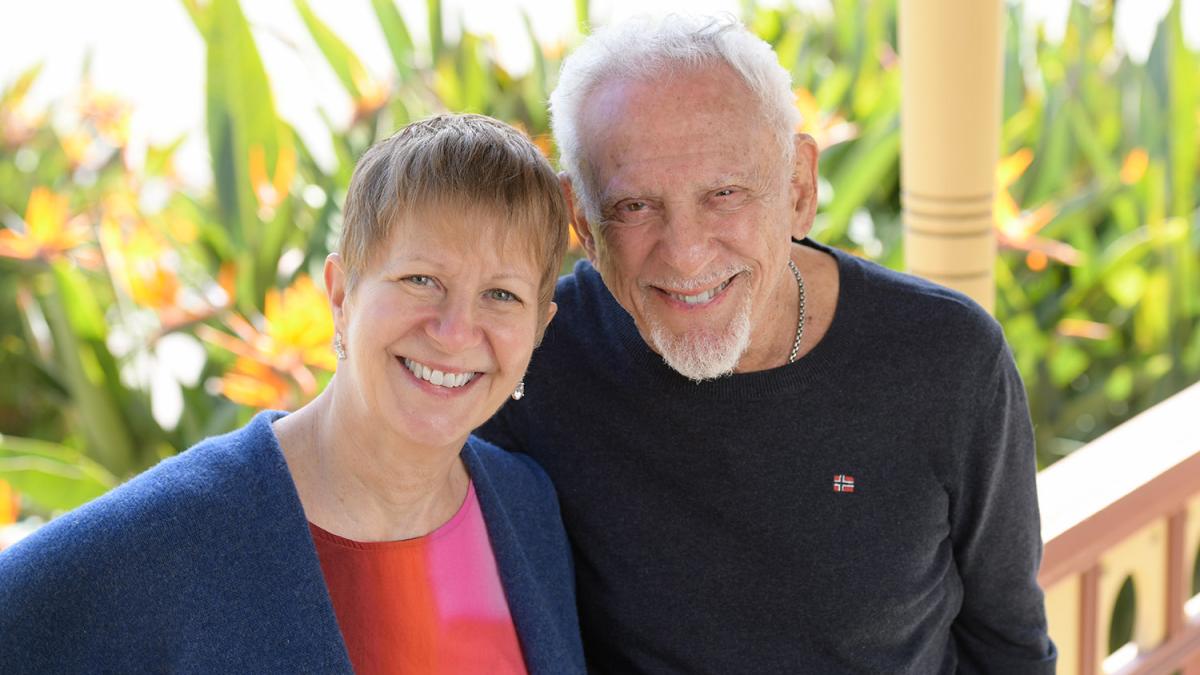 Older couple standing on porch of Seaver House
