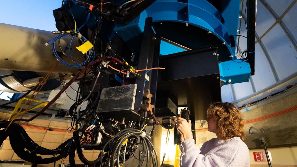 A student works on a giant telescope