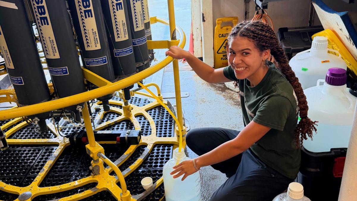 Elle Hawthorne samples water from a CTD rosette.