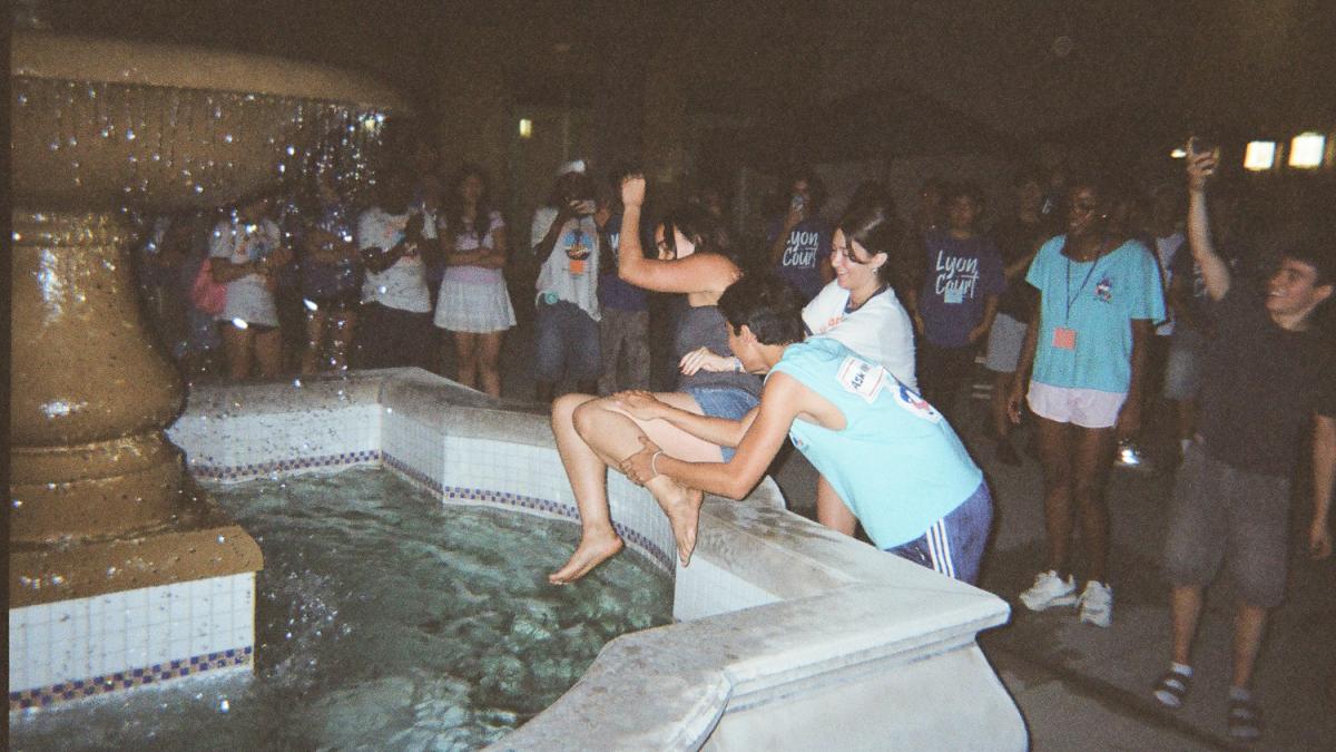 A student gets tossed into a fountain