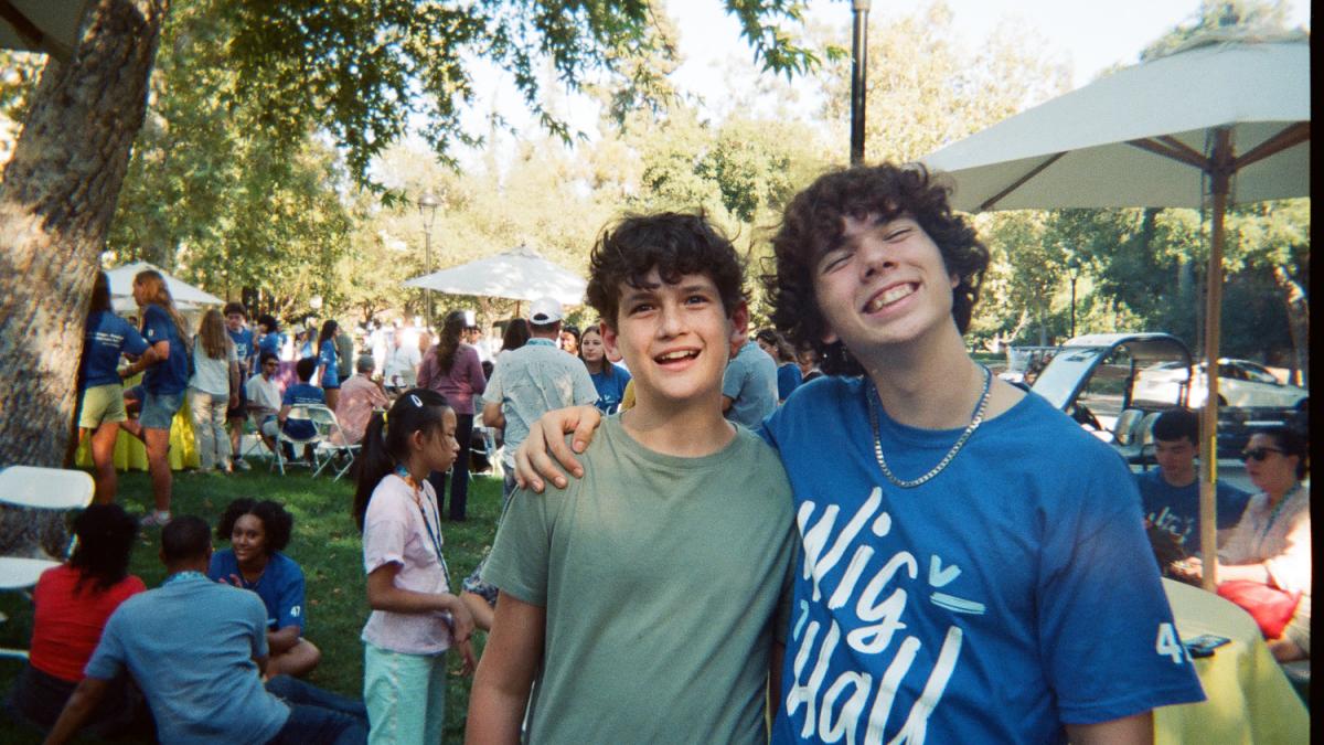 Students smile on lawn