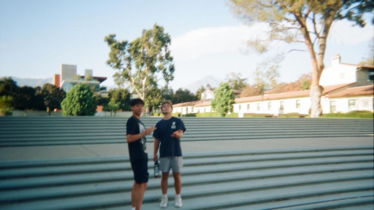 Two students standing on stairs