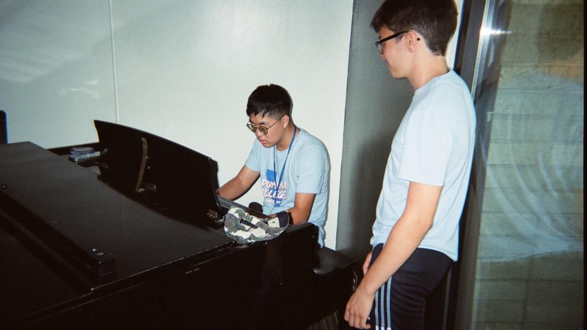 Two students look at a computer