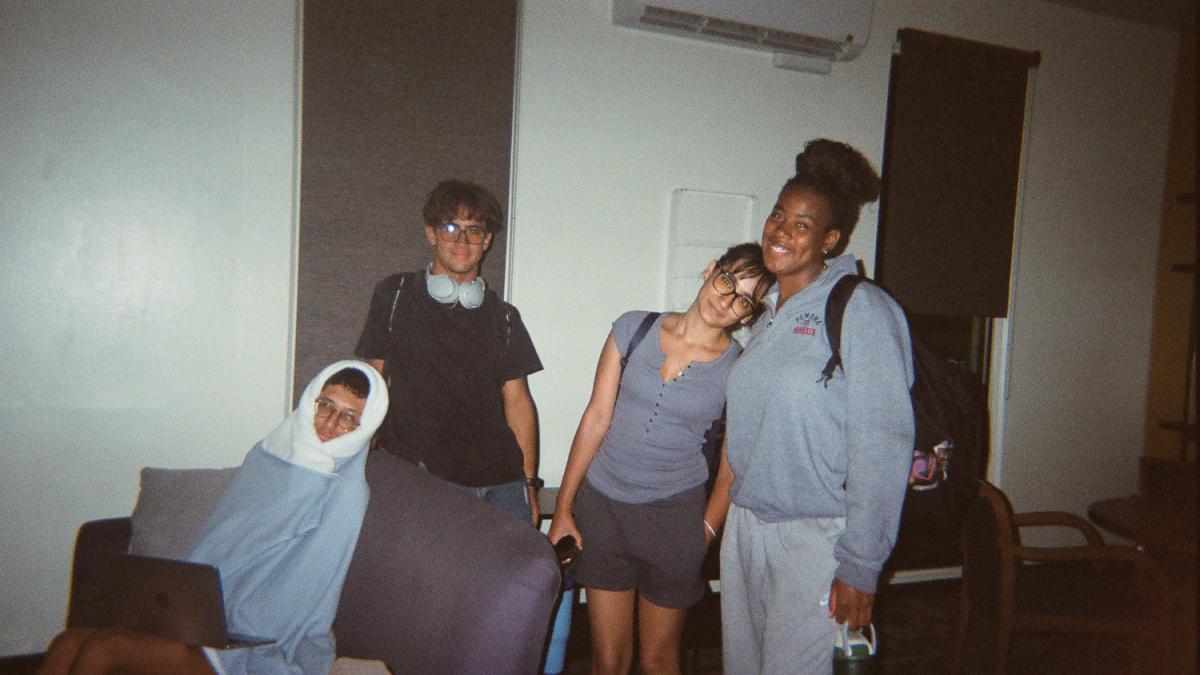 Standing students smile