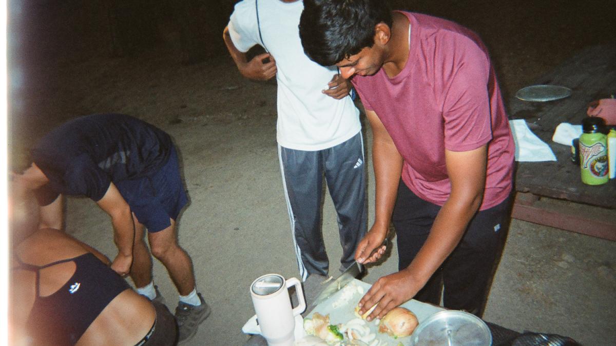 A student cuts a vegetable