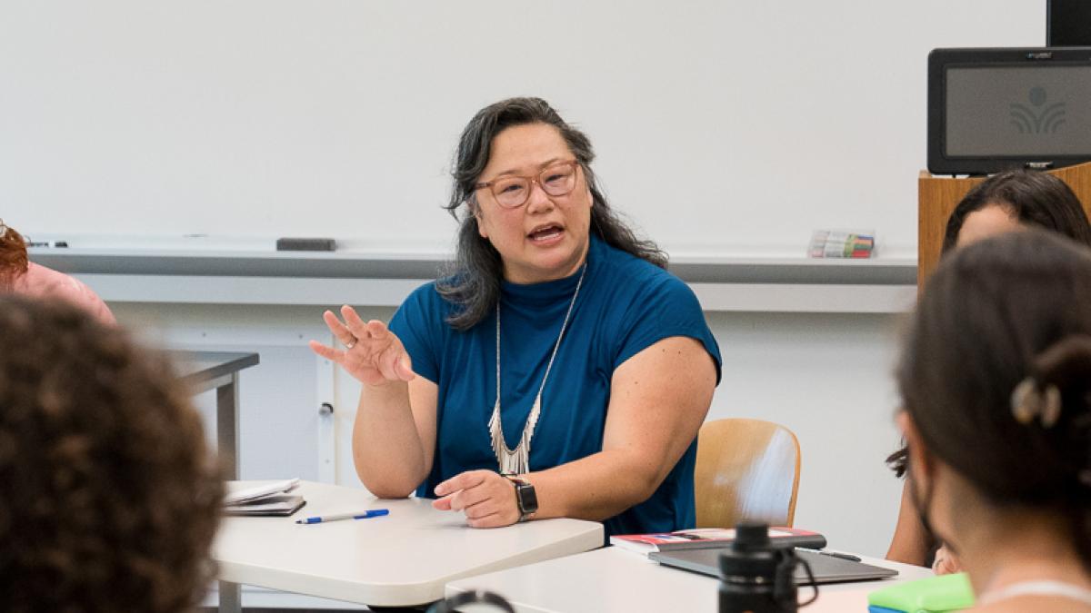 A teacher talks to students