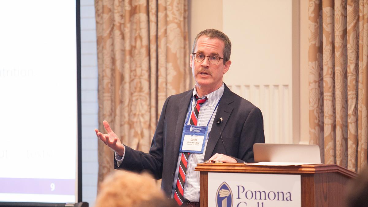 Professor David Menefee-Libey speaking to alumni