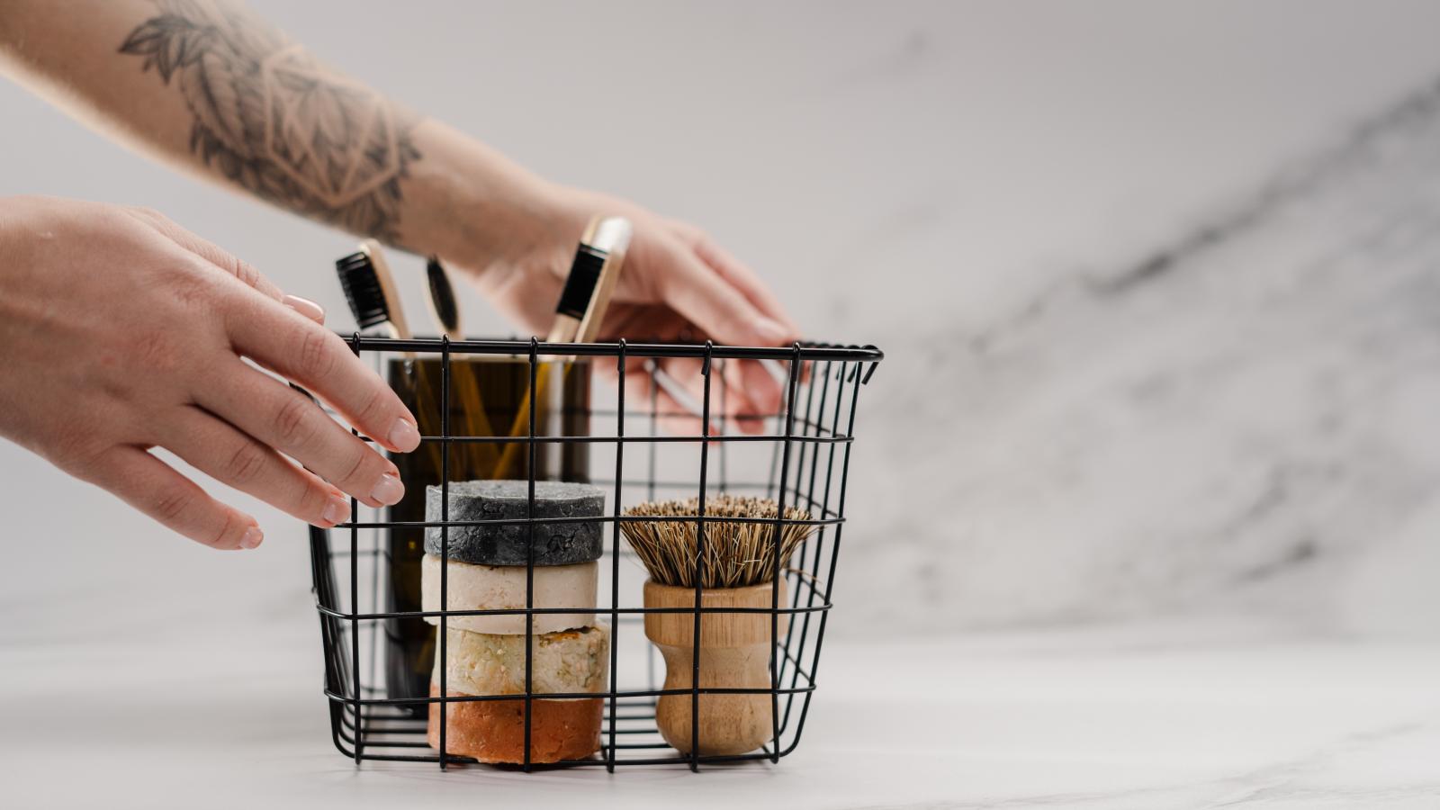 Metal wire basket with reusable bathroom supplies