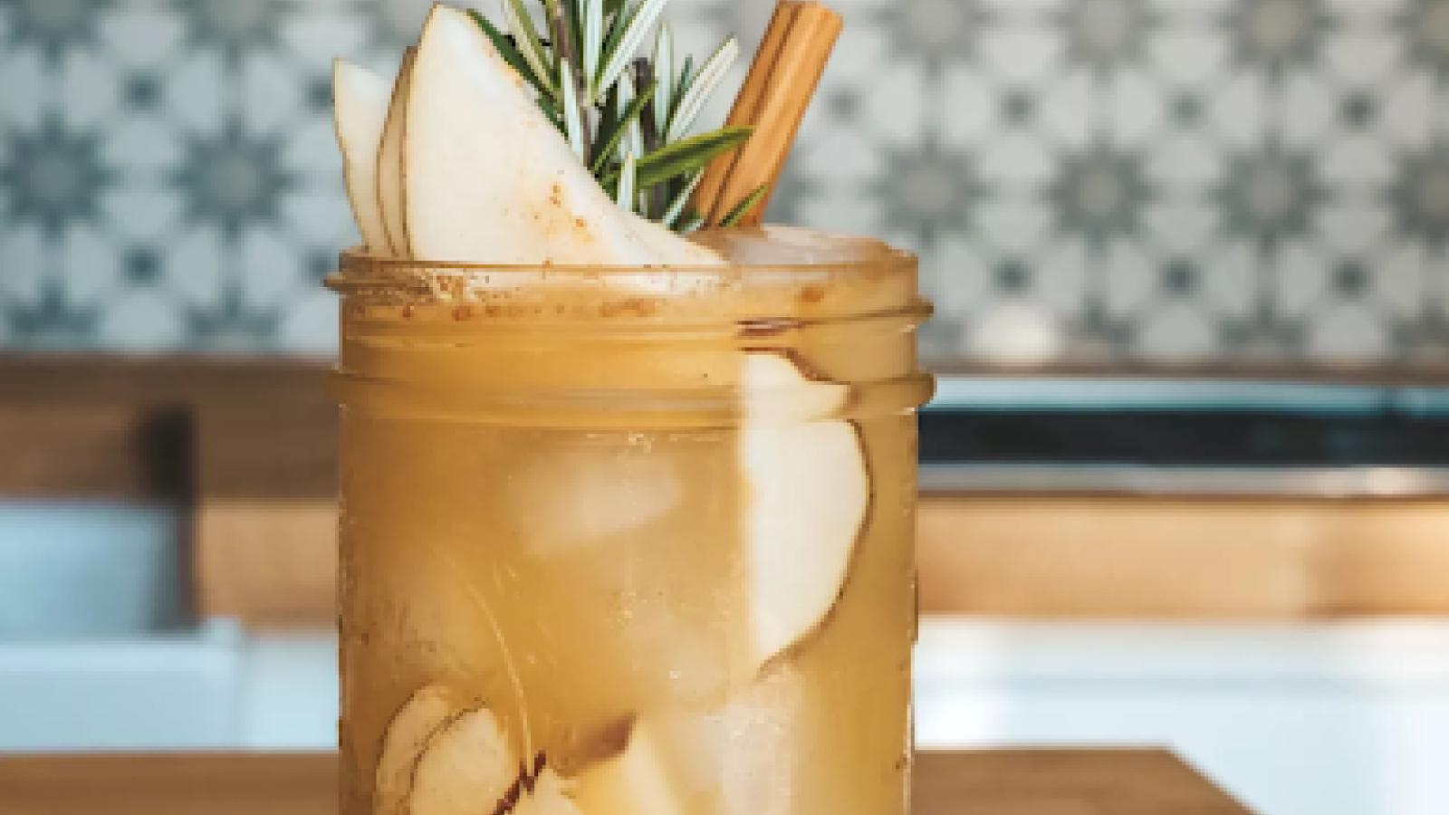 A mixed drink in a mason jar glass