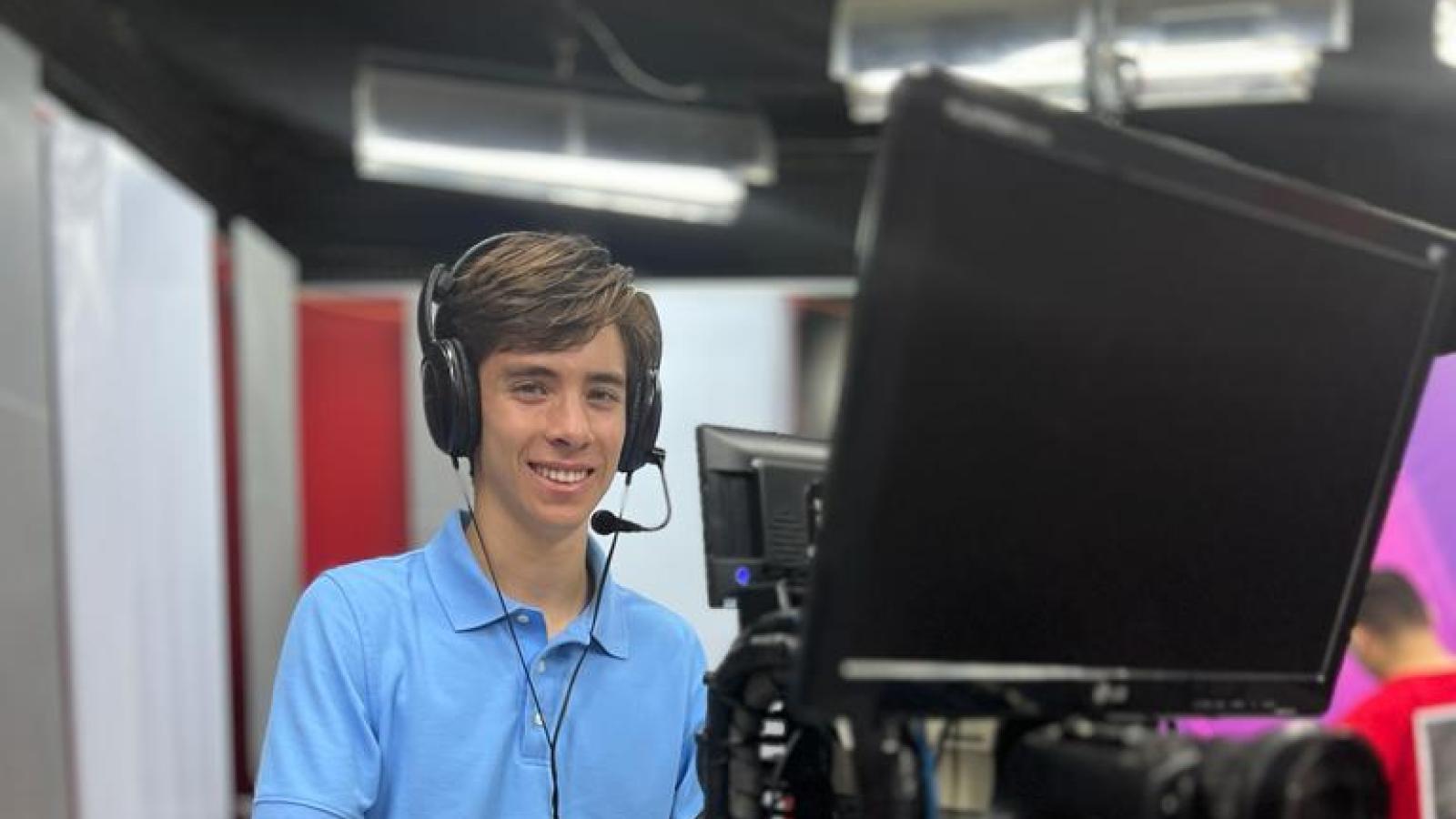 Sebastian Groom standing behind a camera