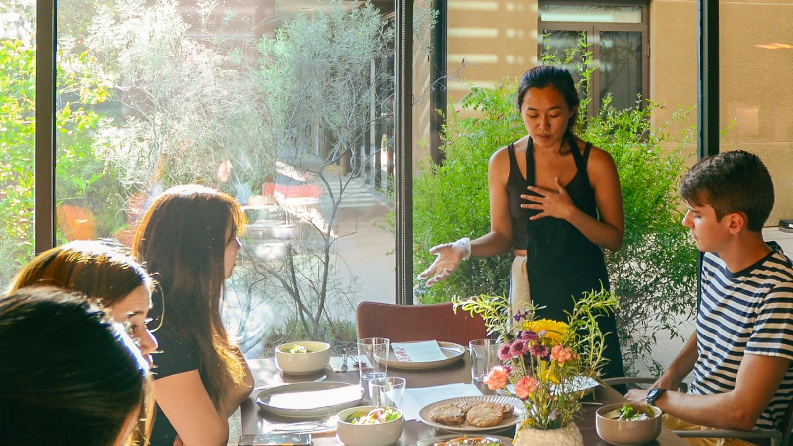 Betsy Ding serves dinner in Dialynas Hall