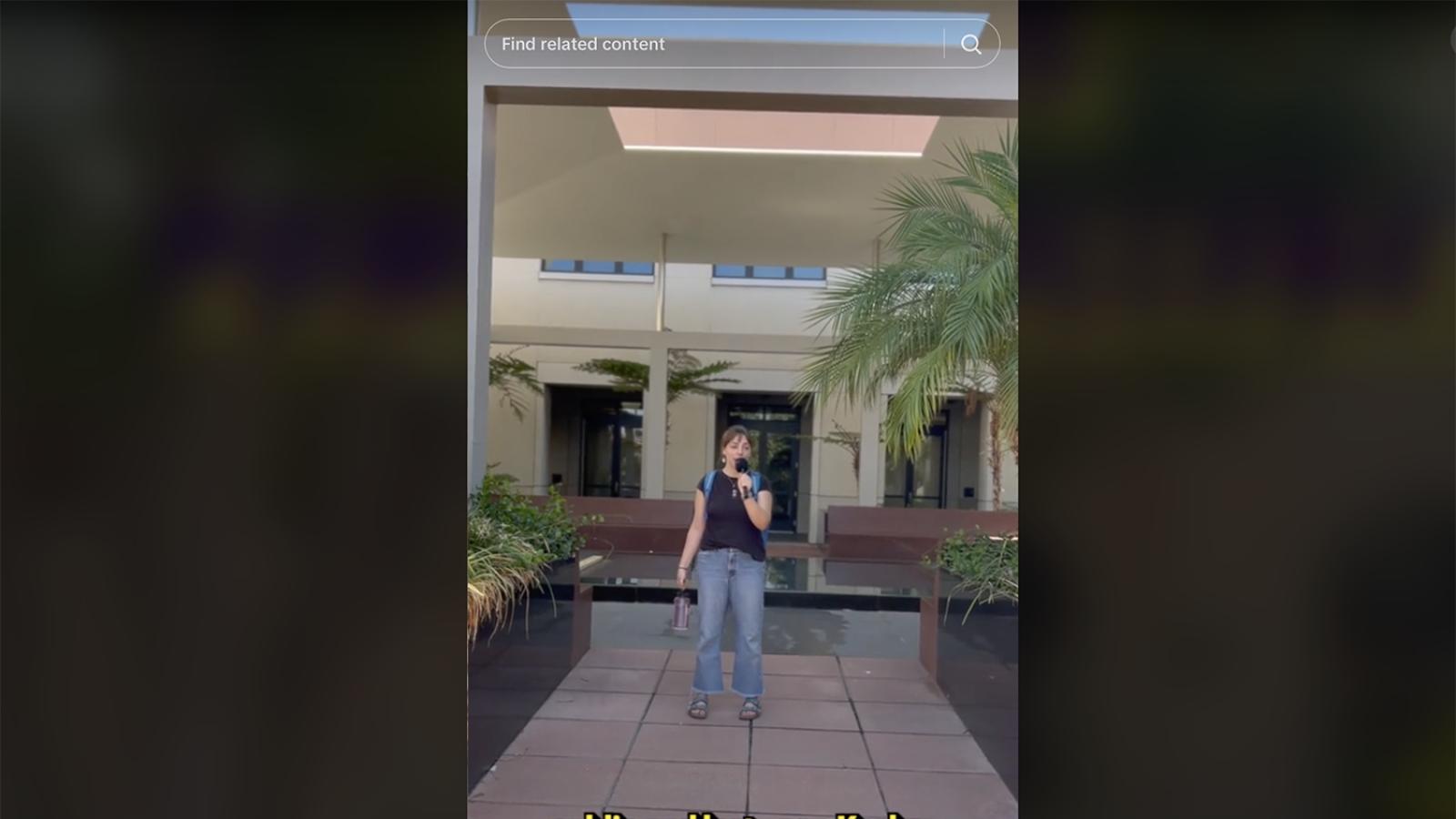 Video frame of student standing on campus 