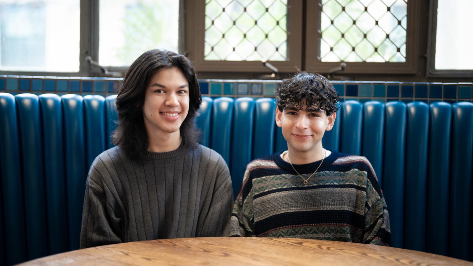 Thomas Aguilar and Ricardo Camacho seated at restaurant