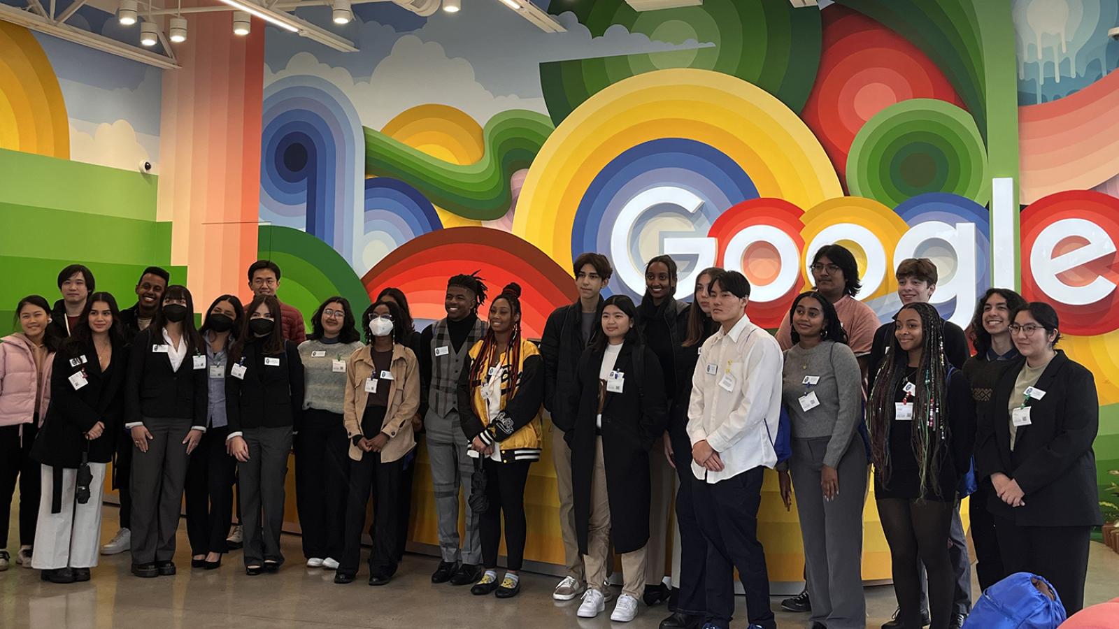 Pomona Smart Start Fellows at Google with big, colorful Google logo behind the group