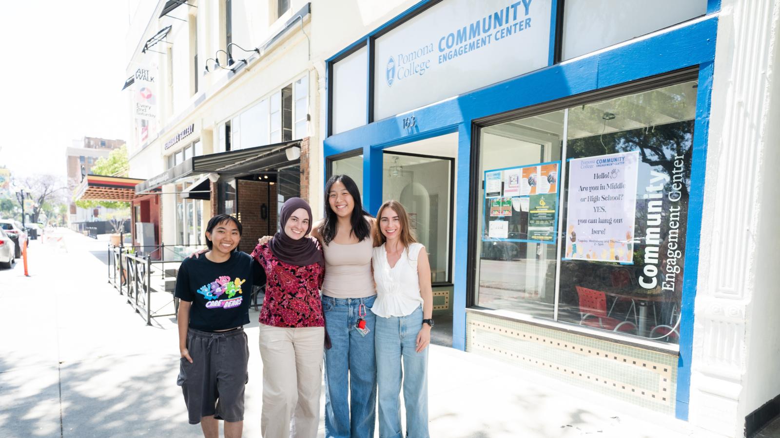 Four students standing in front of the Pomona College Community Engagement Center
