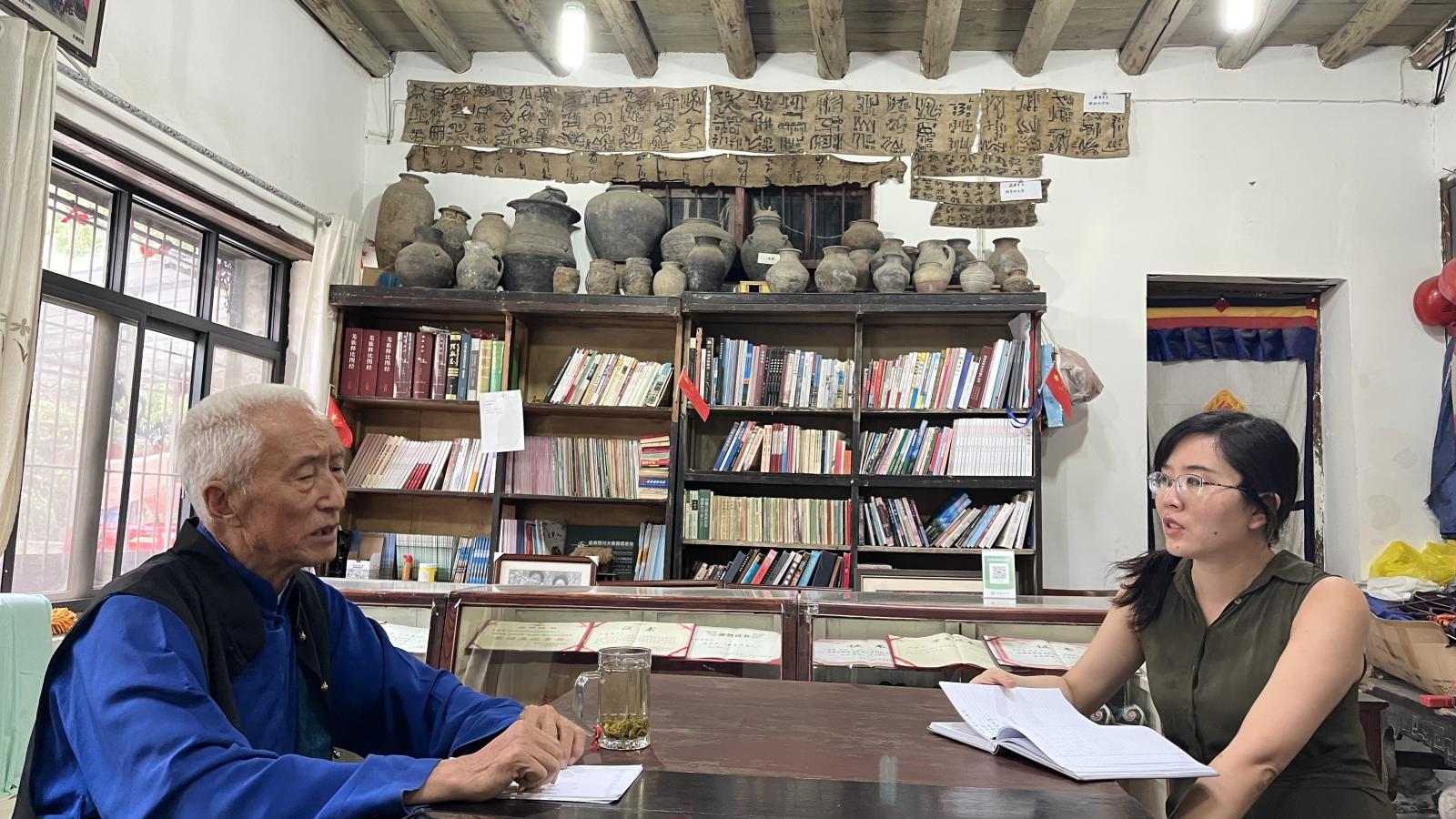 A man sits across a table from Yanshuo Zhang