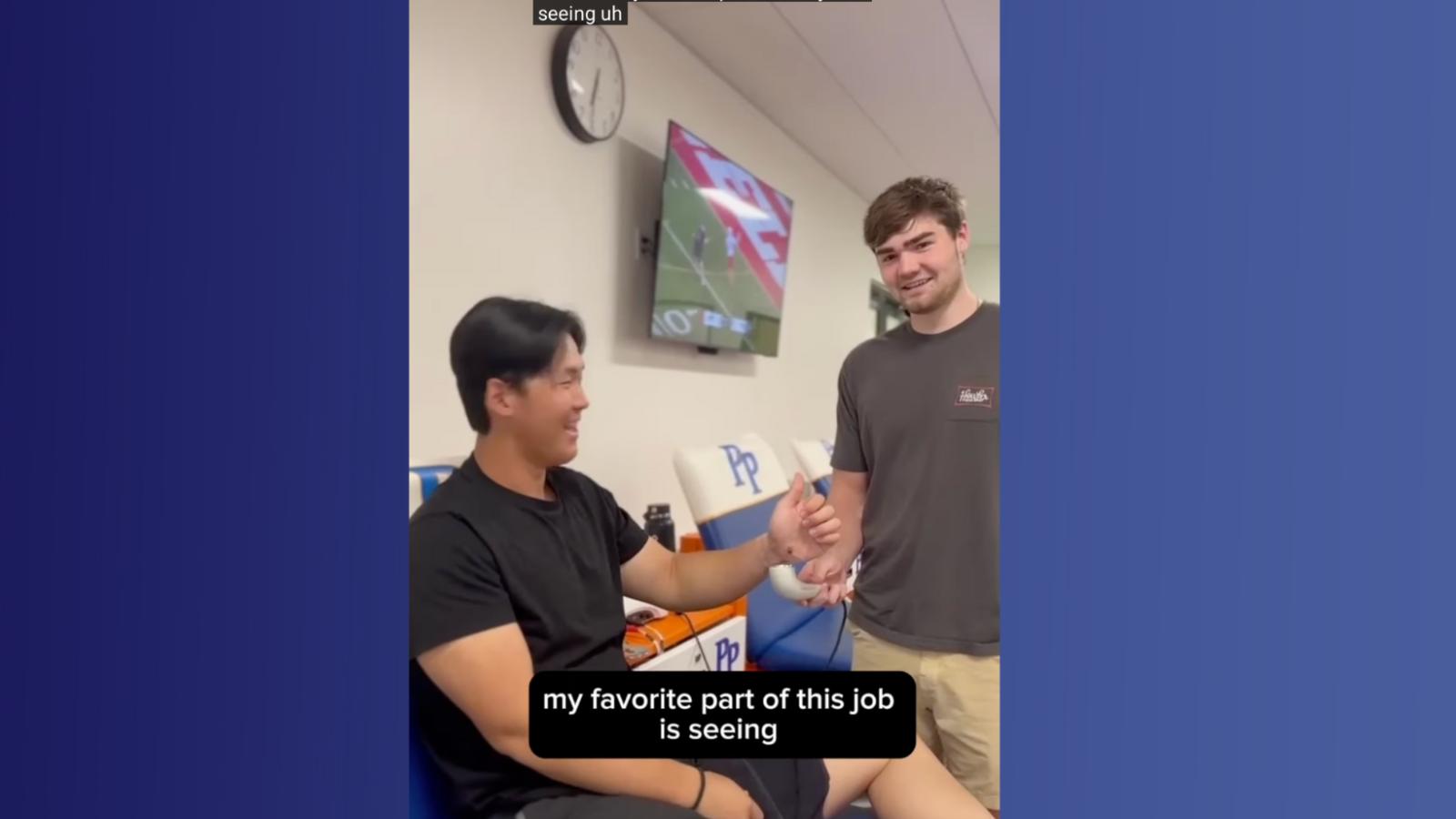 Student talking to other student in training room