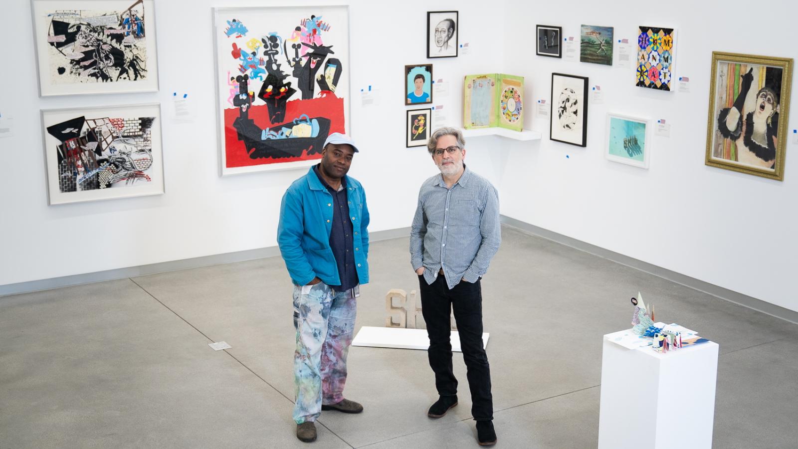 Two men stand in an art museum