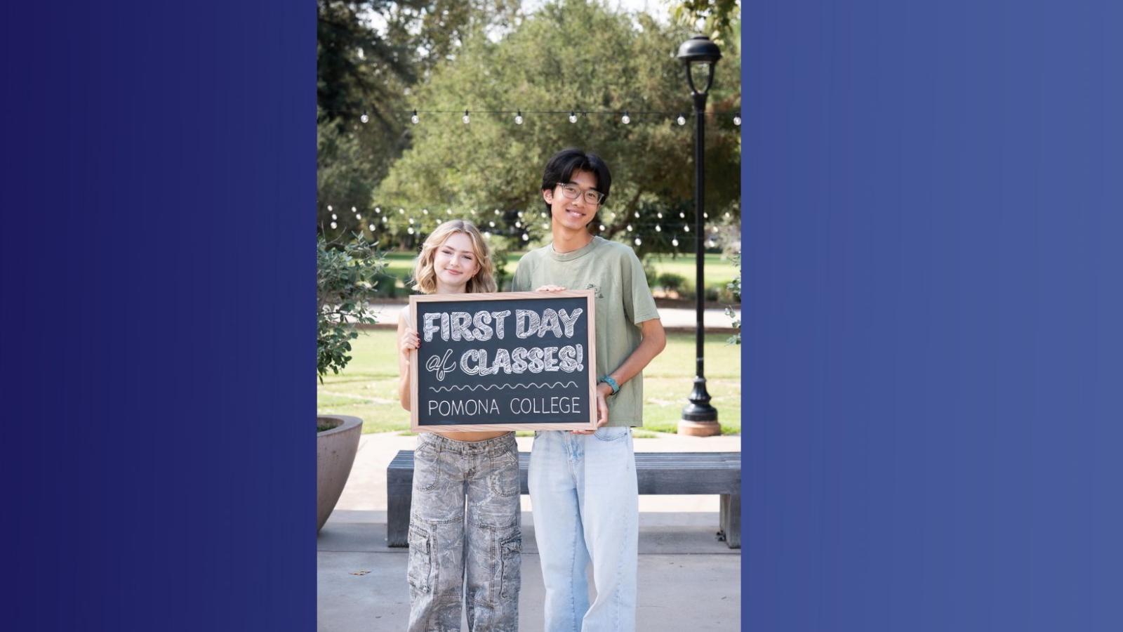 Two students holding a sign