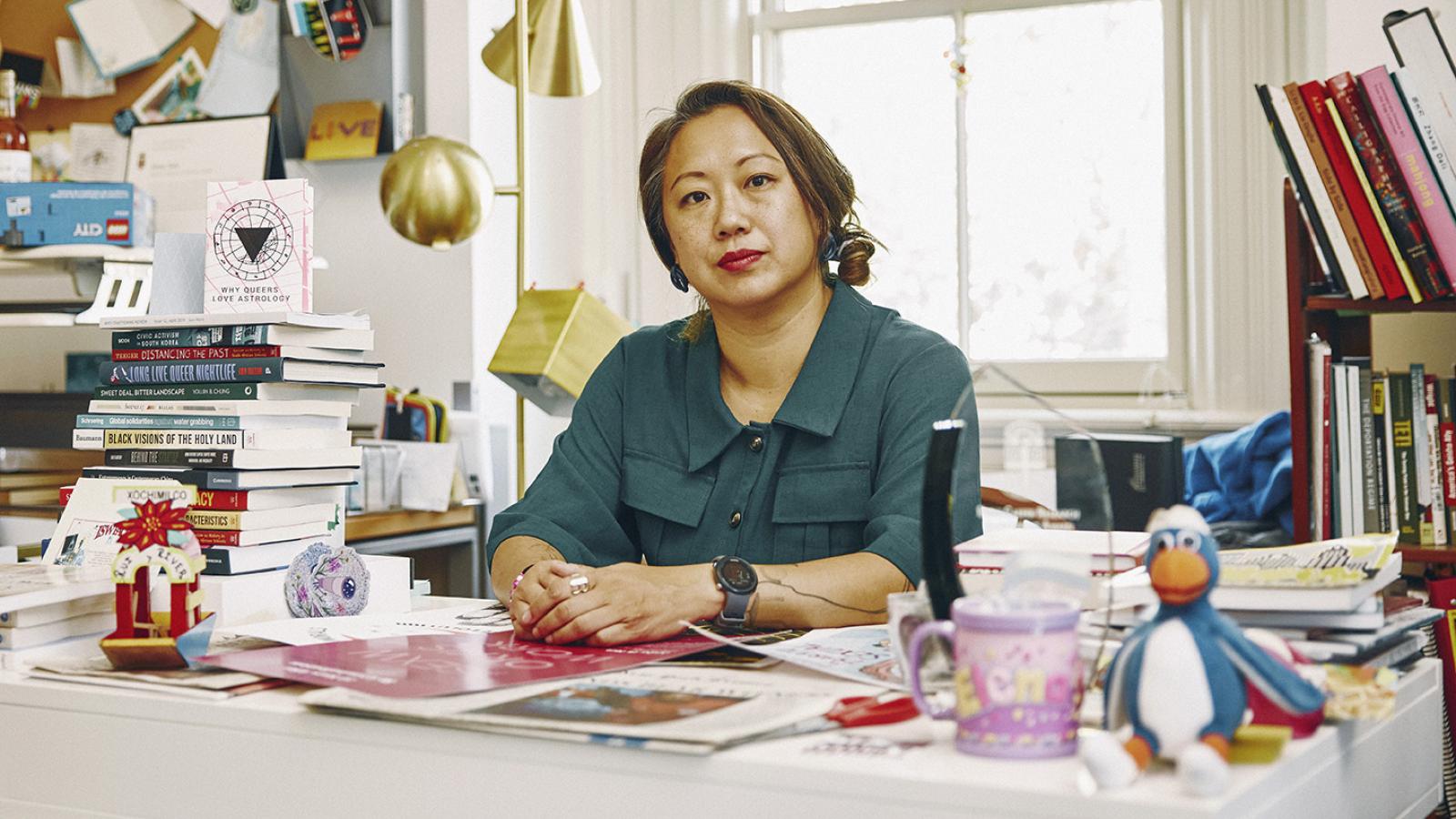 Elena Shih at her desk in her office