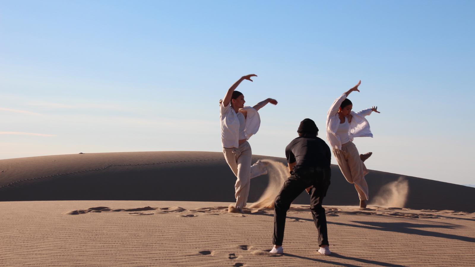 Two people dancing in the desert