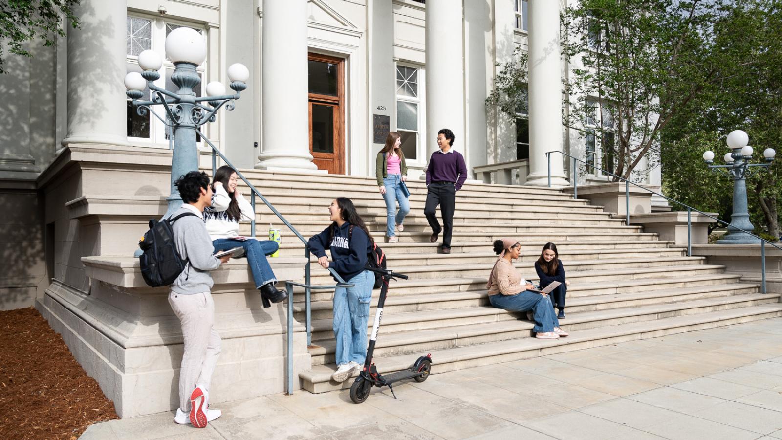 students sitting on carnegie building steps
