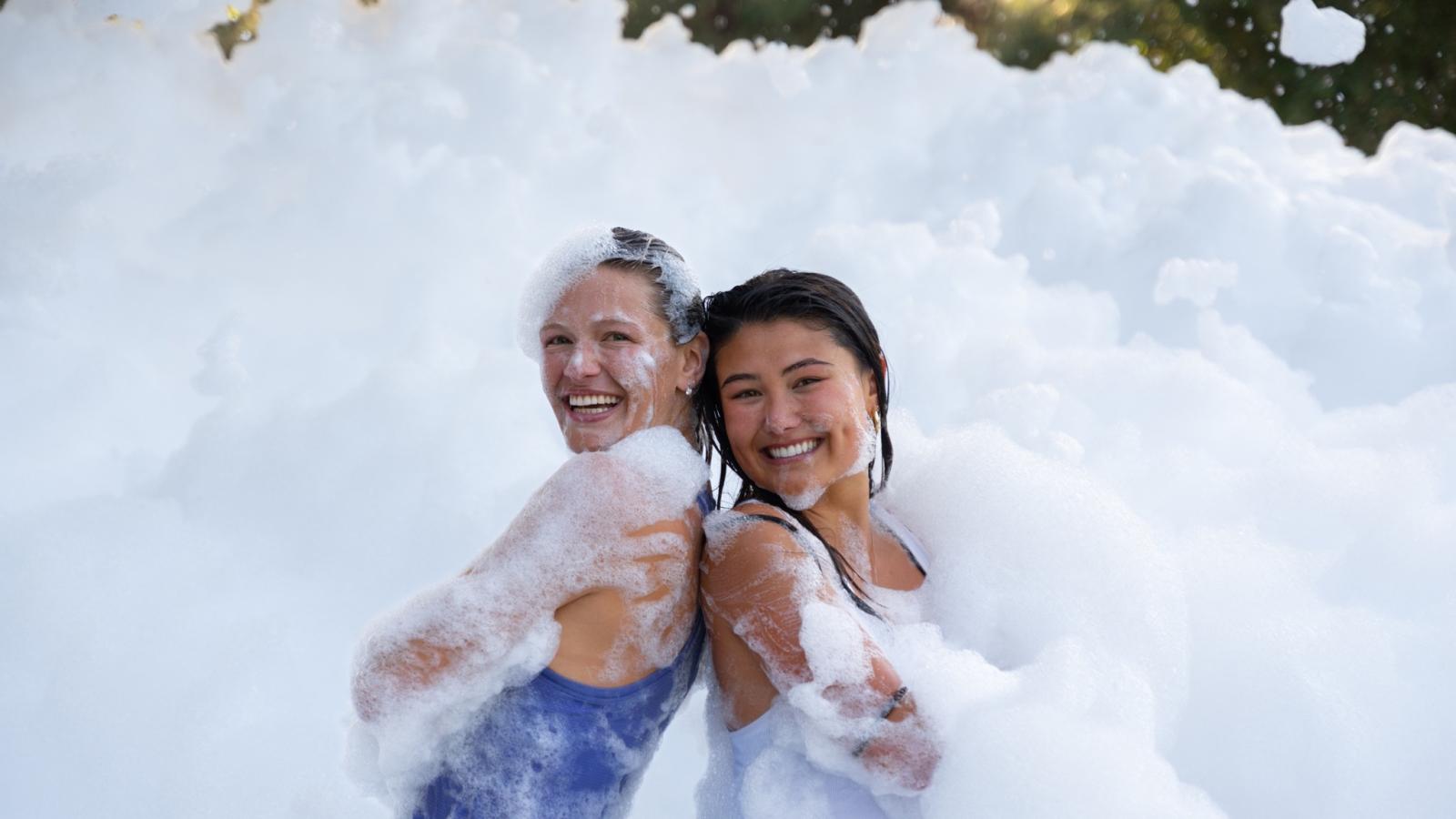 Two students in foam pile