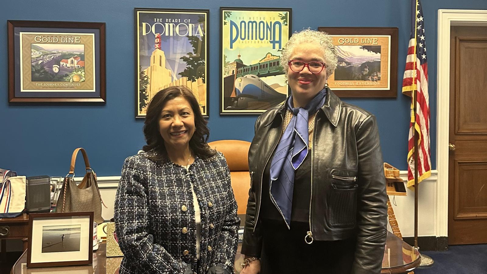 Two people standing in an office