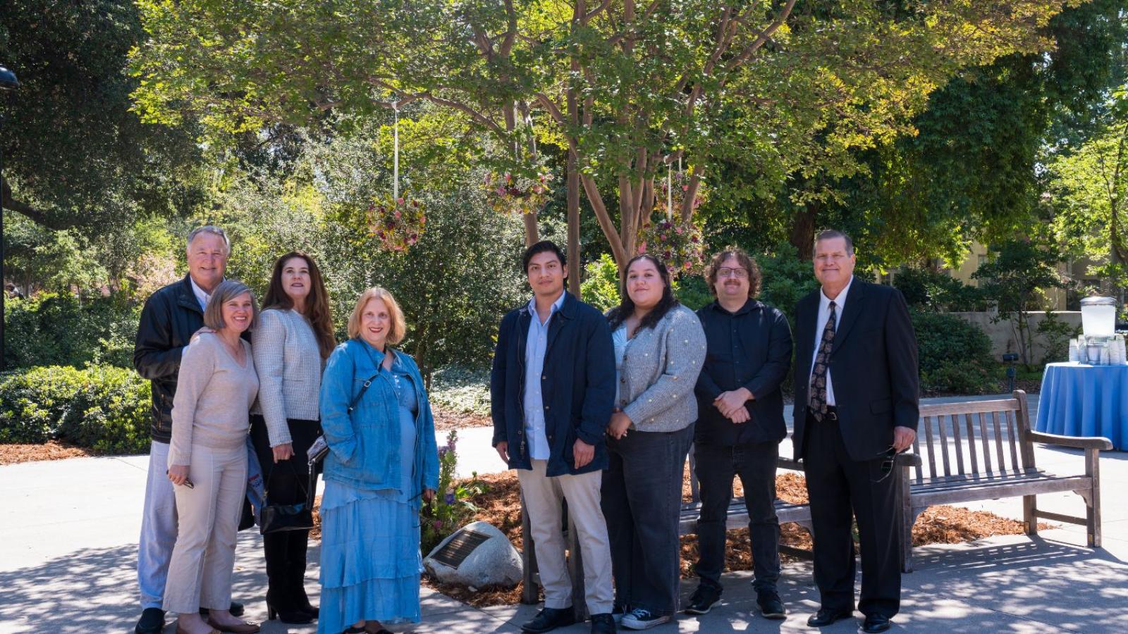 Linda Mazur's family in front of her bench and plaque
