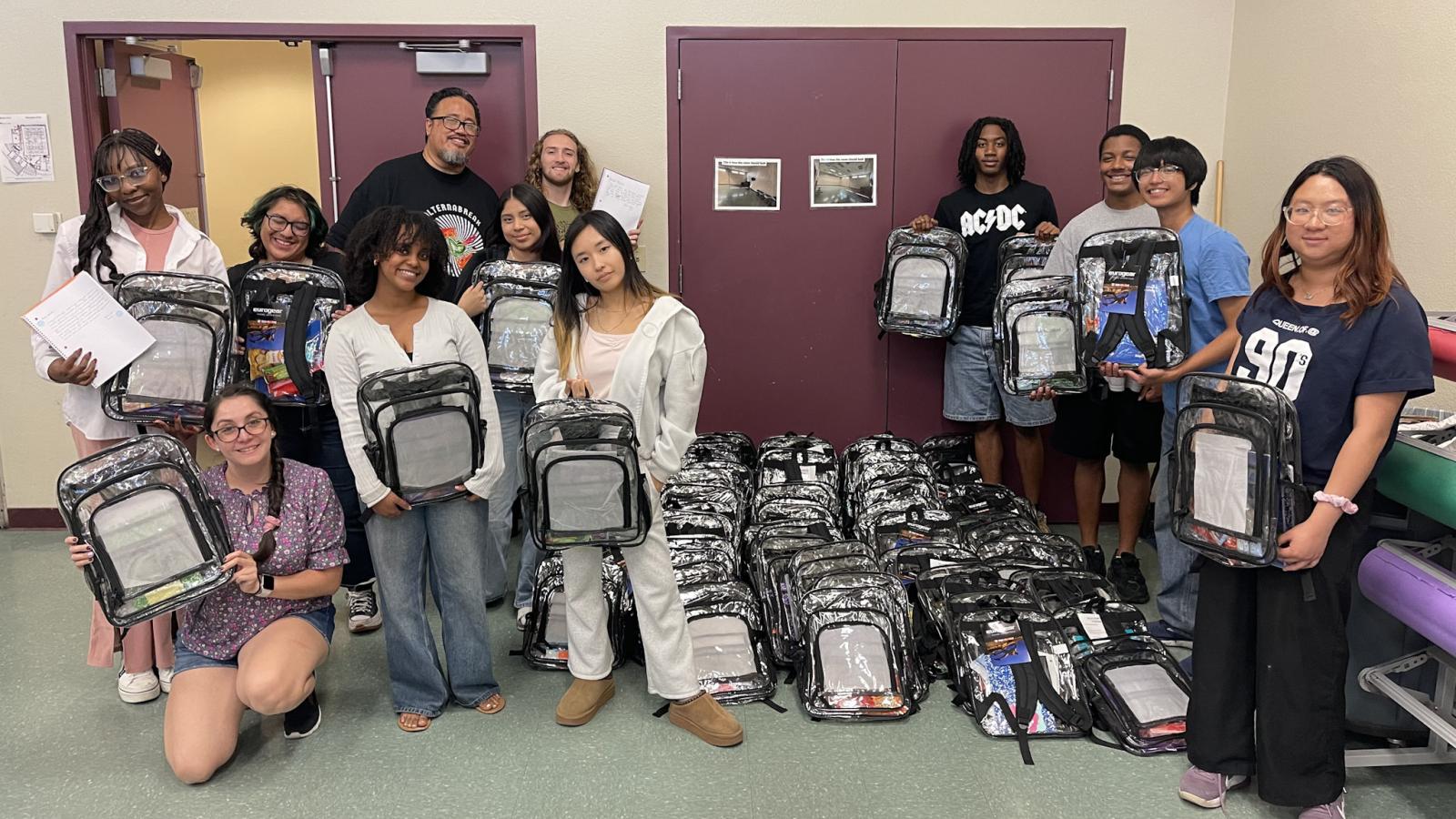 A group of students holding clear backpacks