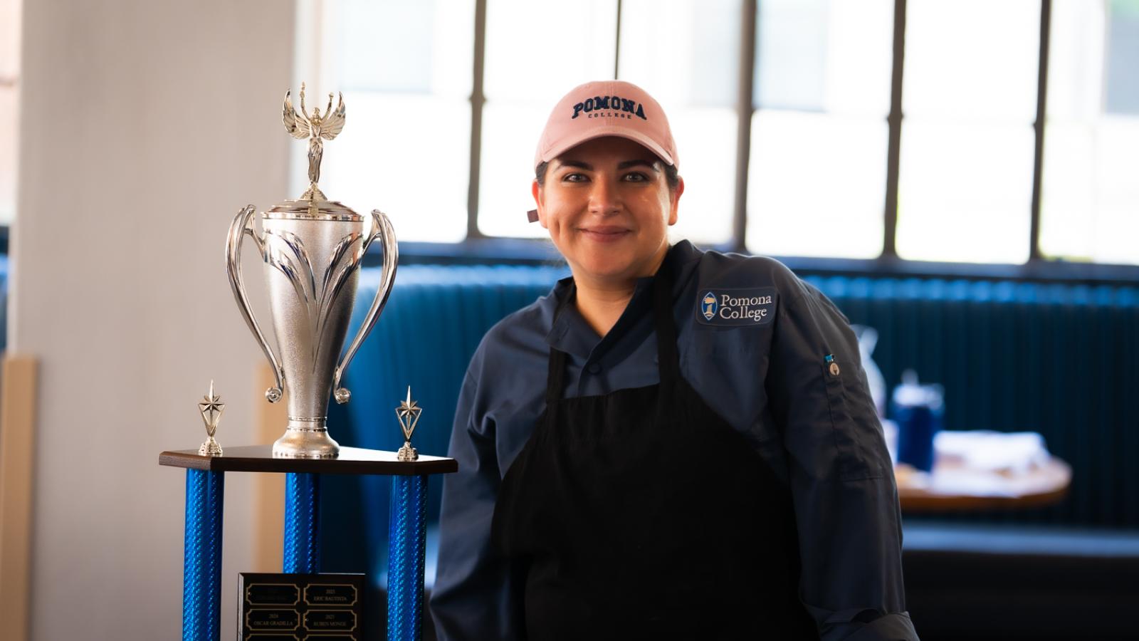 Woman stands with trophy