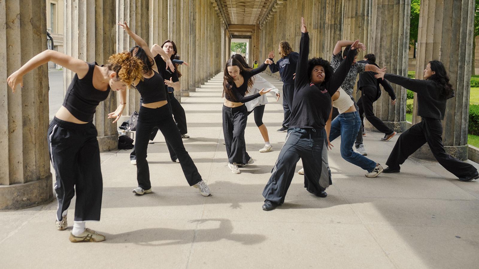 Students perform as a movement choir outdoors in Berlin.