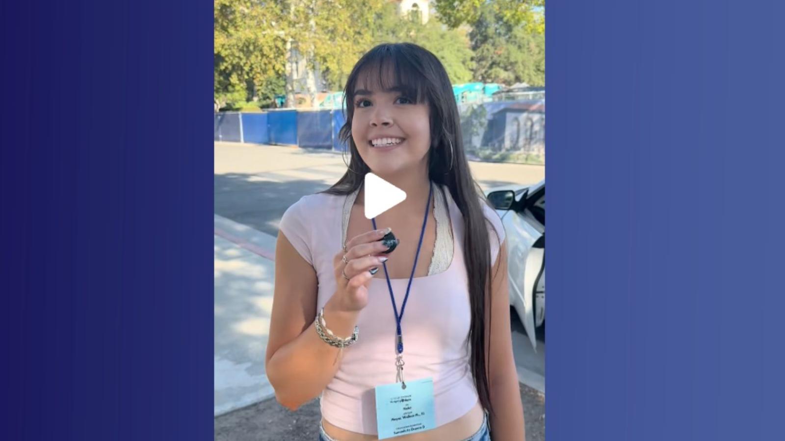 A student holds a microphone