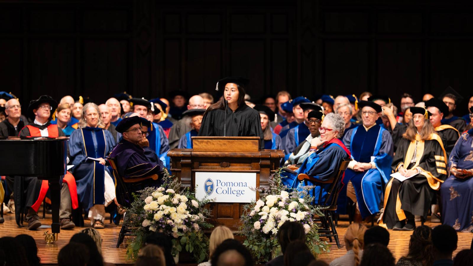 A woman stands at a podium