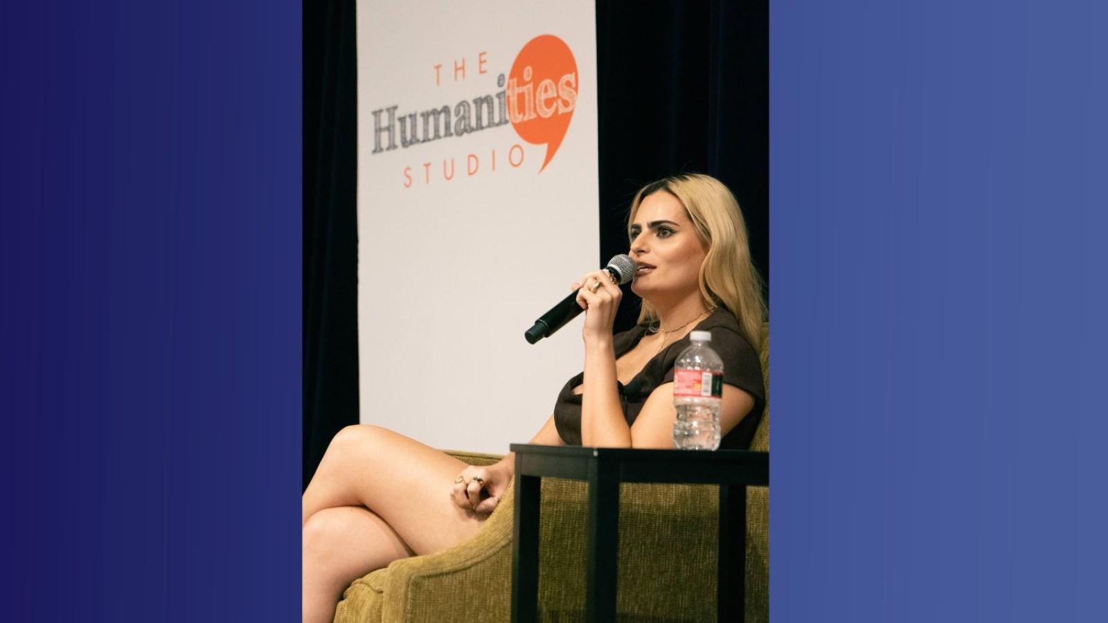 A woman holds a microphone