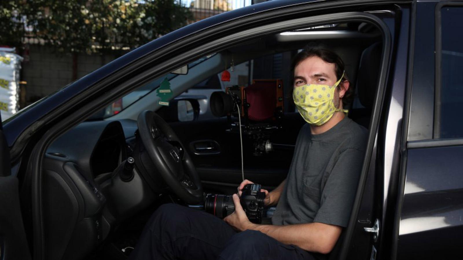 Photographer Ian Byers-Gamber in his Honda, the vehicle that frames portraits he’s shot during the pandemic.(Dania Maxwell / Los Angeles Times)