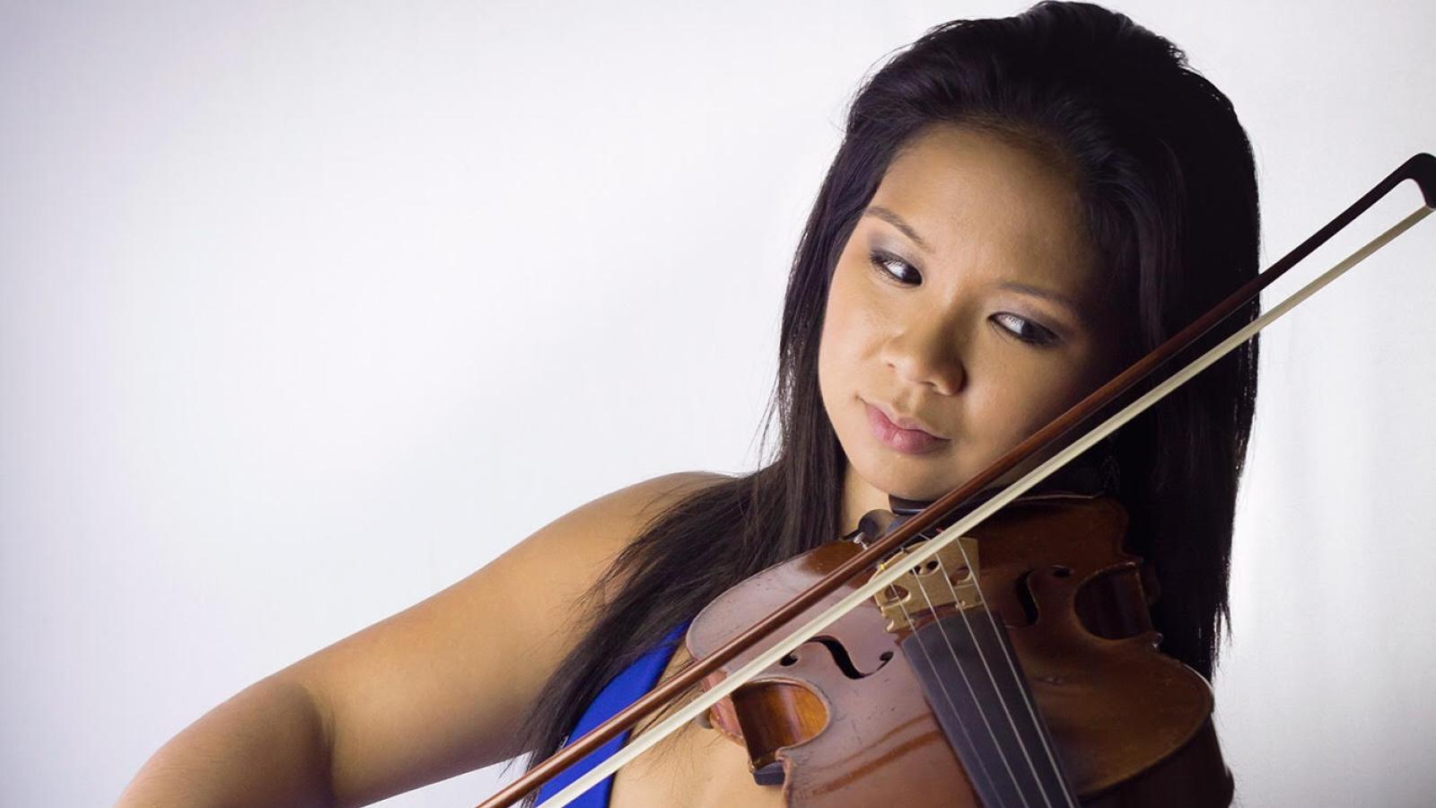 Alumna Caroline Fernandez plays the violin,