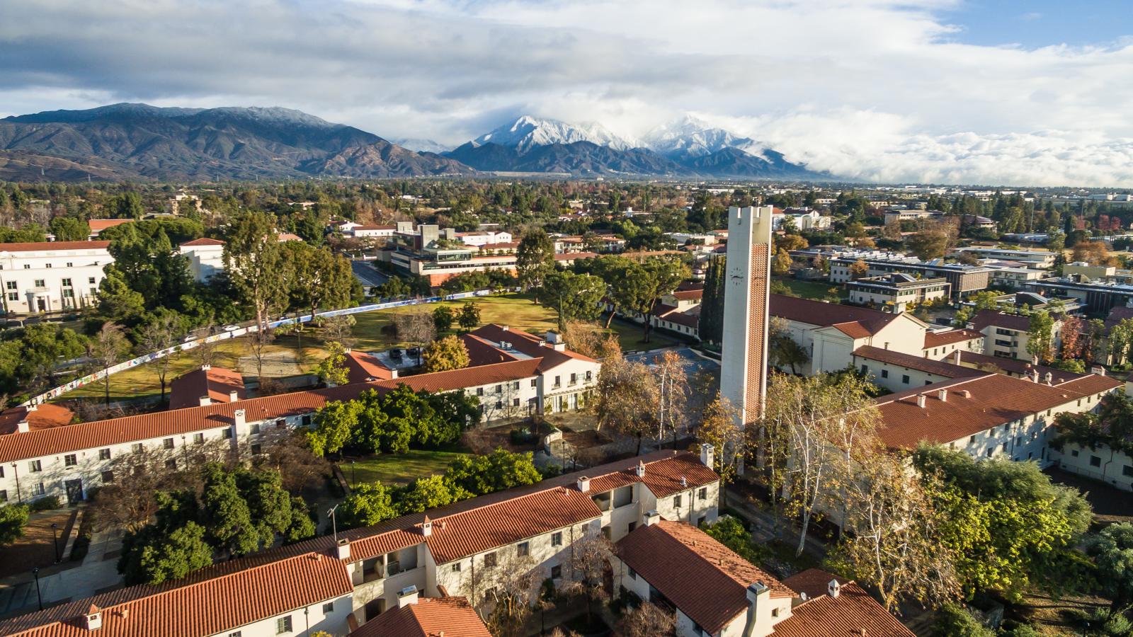Aerial view of campus with the snow-capped San Gabriel Mountains in the background.