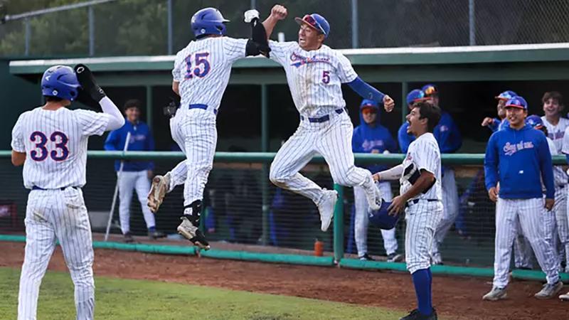 Pomona Pitzer baseball players jump in the air as they celebrate two wins