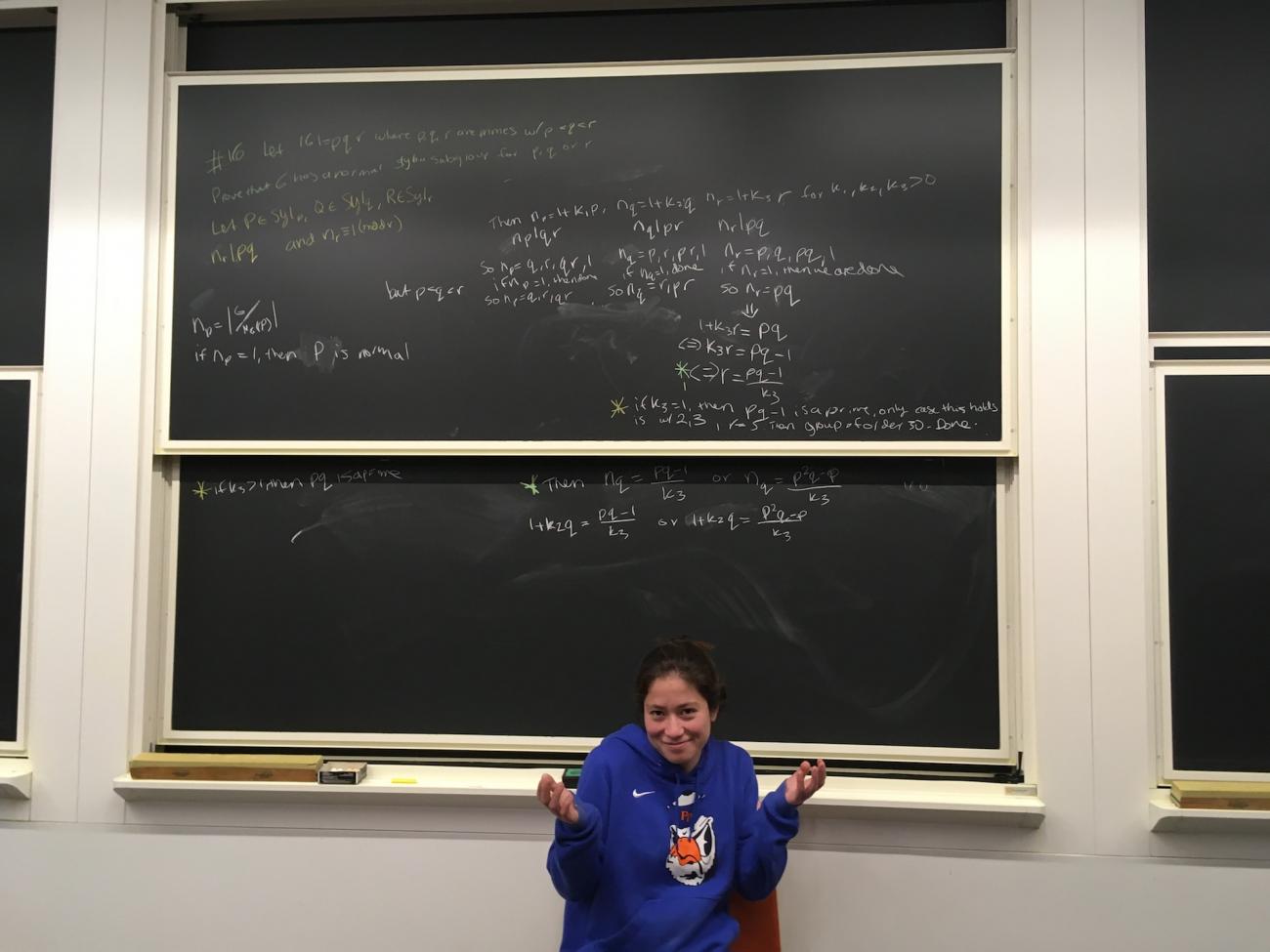 Elena Kim in front of a chalkboard.