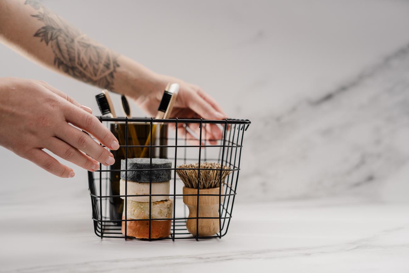 Metal wire basket with reusable bathroom supplies