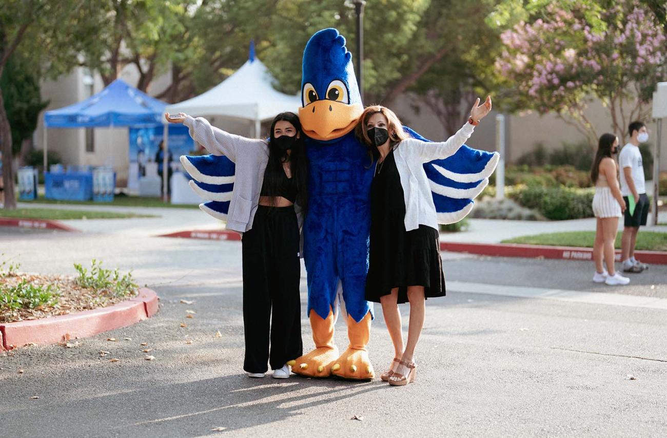 cecil macot poses with a family during move-in day 2021