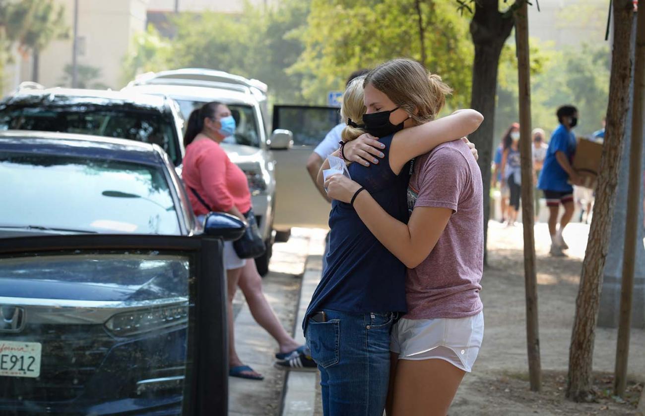 mom and daughter hug during move in