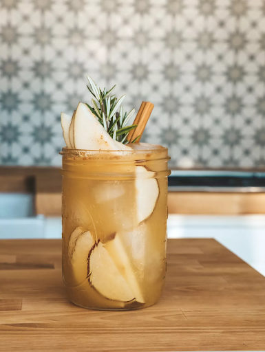 A mixed drink in a mason jar glass