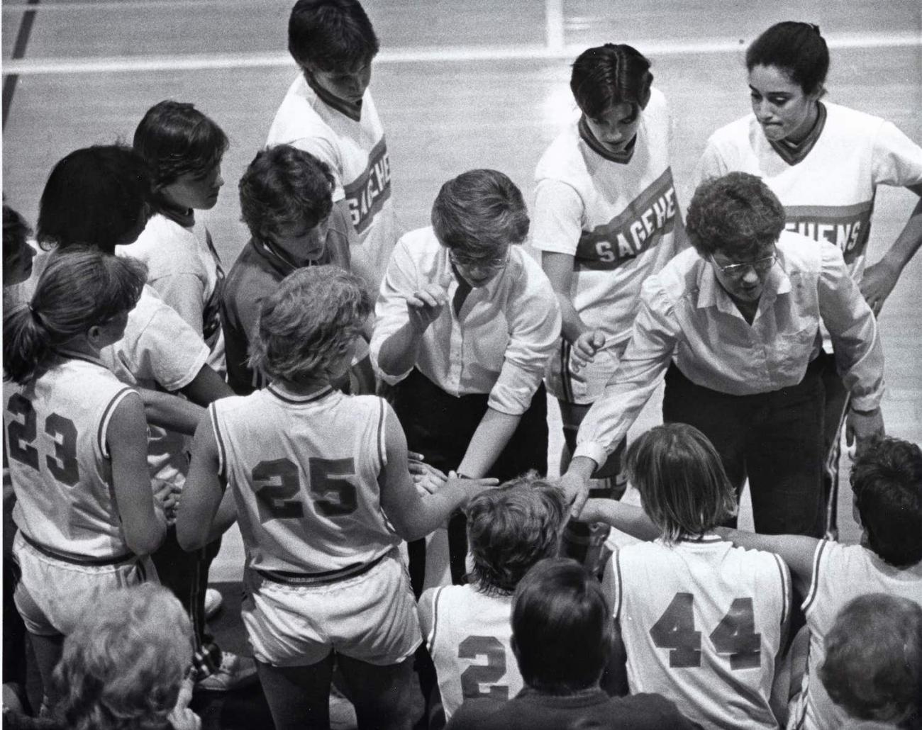 Coach Nancy Breitenstein and her assistant Nettie Morrison in the huddle with a Sagehens team. 